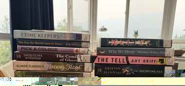 Two stacks of large-print library books Bette had checked out at the time of her death